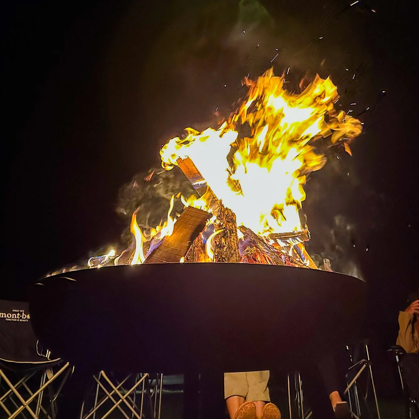 夜のキャンプ場で燃え盛る焚き火